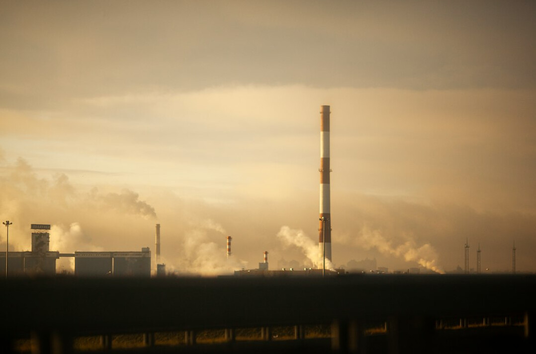 Industrial factory chimneys releasing smoke into the sky